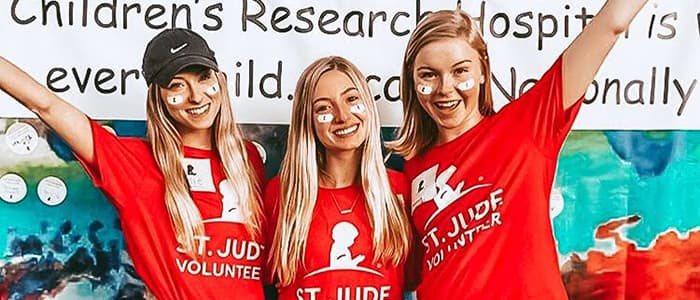 Three women posing with St. Jude Volunteer T-Shirts.