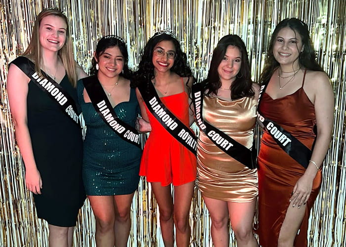 Five women poses with sashes that display 'Diamond Court'.